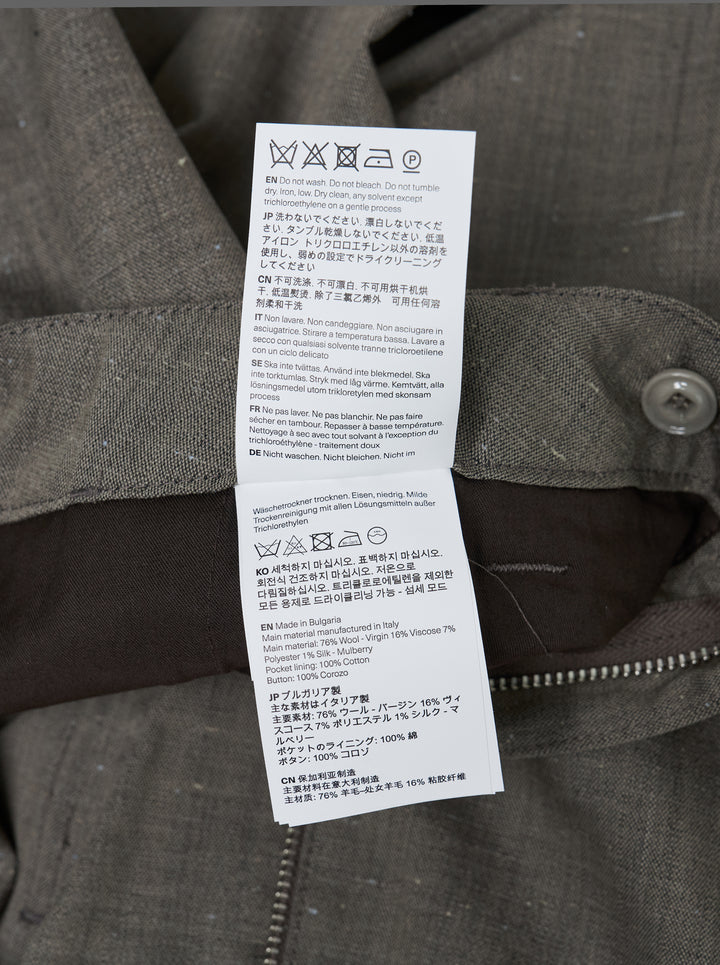 Our Legacy Still Chino Pants in heathered grey — wide-leg tailored trousers with double pleats and turn-up cuffs, front view on white background - view 3