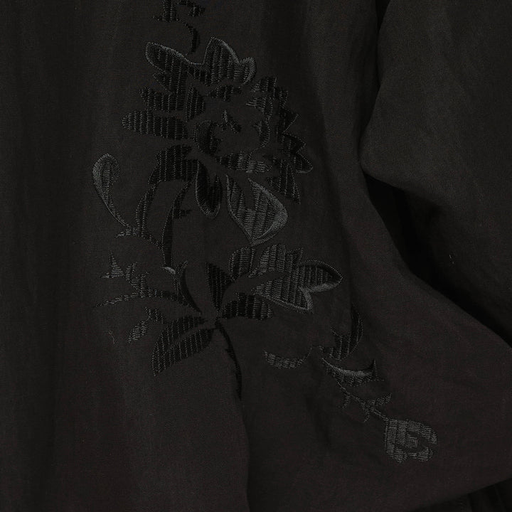 Yohji Yamamoto Tuck & Drape Blouse in black, featuring an asymmetric draped hem, button-through front, point collar, and long sleeves with buttoned cuffs - view 3