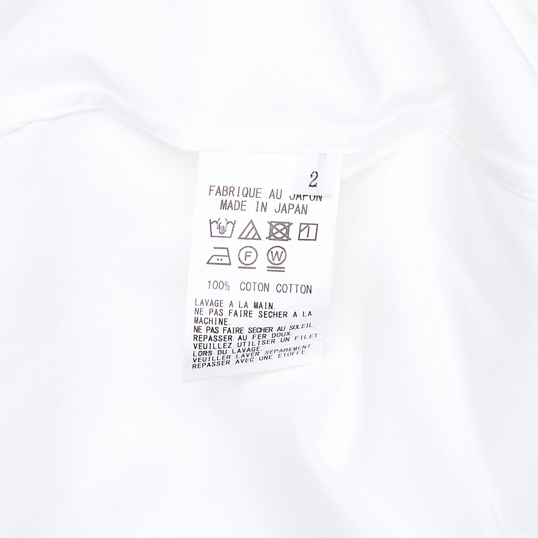 Y's U-Sailor Collar Shirt in white, featuring an oversized dramatic U-shaped sailor collar, concealed front placket, single chest patch pocket, and long sleeves with buttoned cuffs