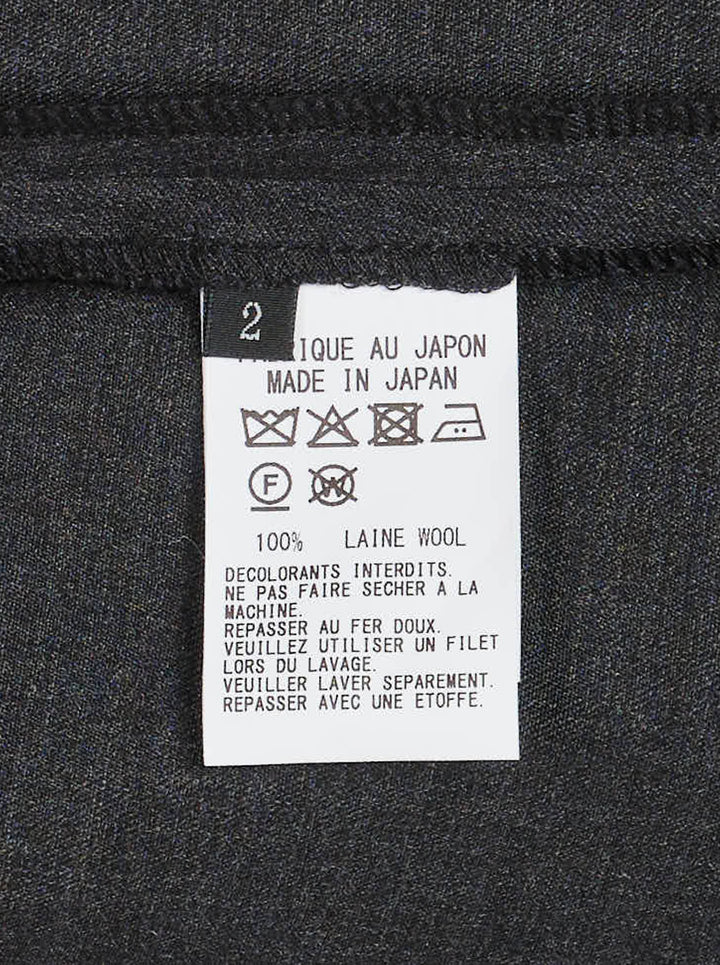 Y's charcoal grey wool salopette dress with crossover bib, buckled straps and oversized side pockets, shown from the front - view 3
