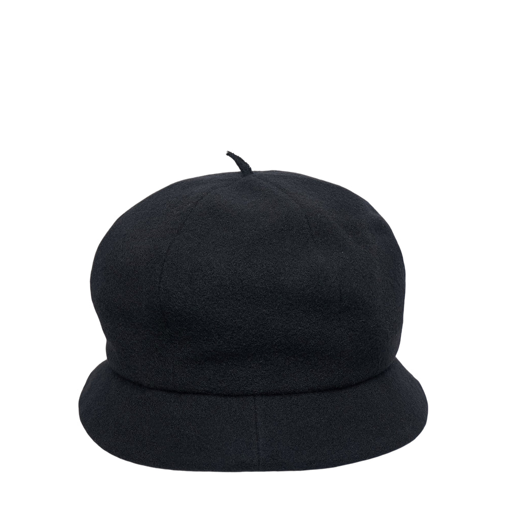 Y's black wool beret cap with a rounded dome crown, small fabric pip at the apex, and a soft downward-curved unstructured brim, photographed on a white background - view 2