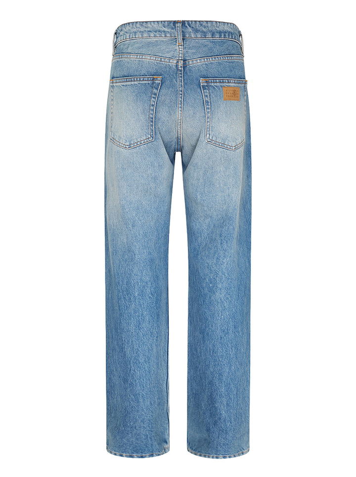 MM6 Maison Margiela light wash blue straight-leg jeans with a deconstructed asymmetric waistband and button fly, shown front view - view 3