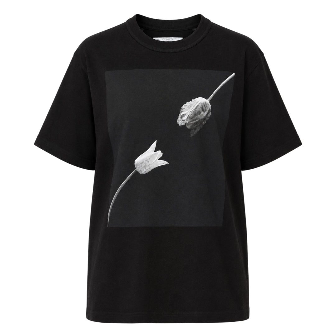 sacai Robert Mapplethorpe Graphic Tee in black, featuring a square monochrome photographic print of two tulips — one in bloom and one wilting — on the chest, with a relaxed boxy fit and crew neckline