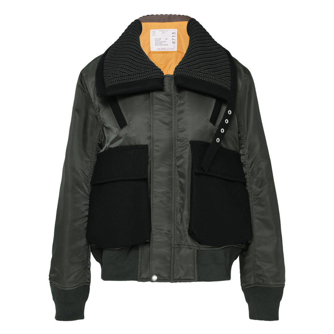 sacai Nylon Twill x Wool Melton Blouson in olive green, featuring an oversized ribbed knit collar, contrast black wool patch pockets, eyelet hardware detail, and orange satin lining at the collar reverse
