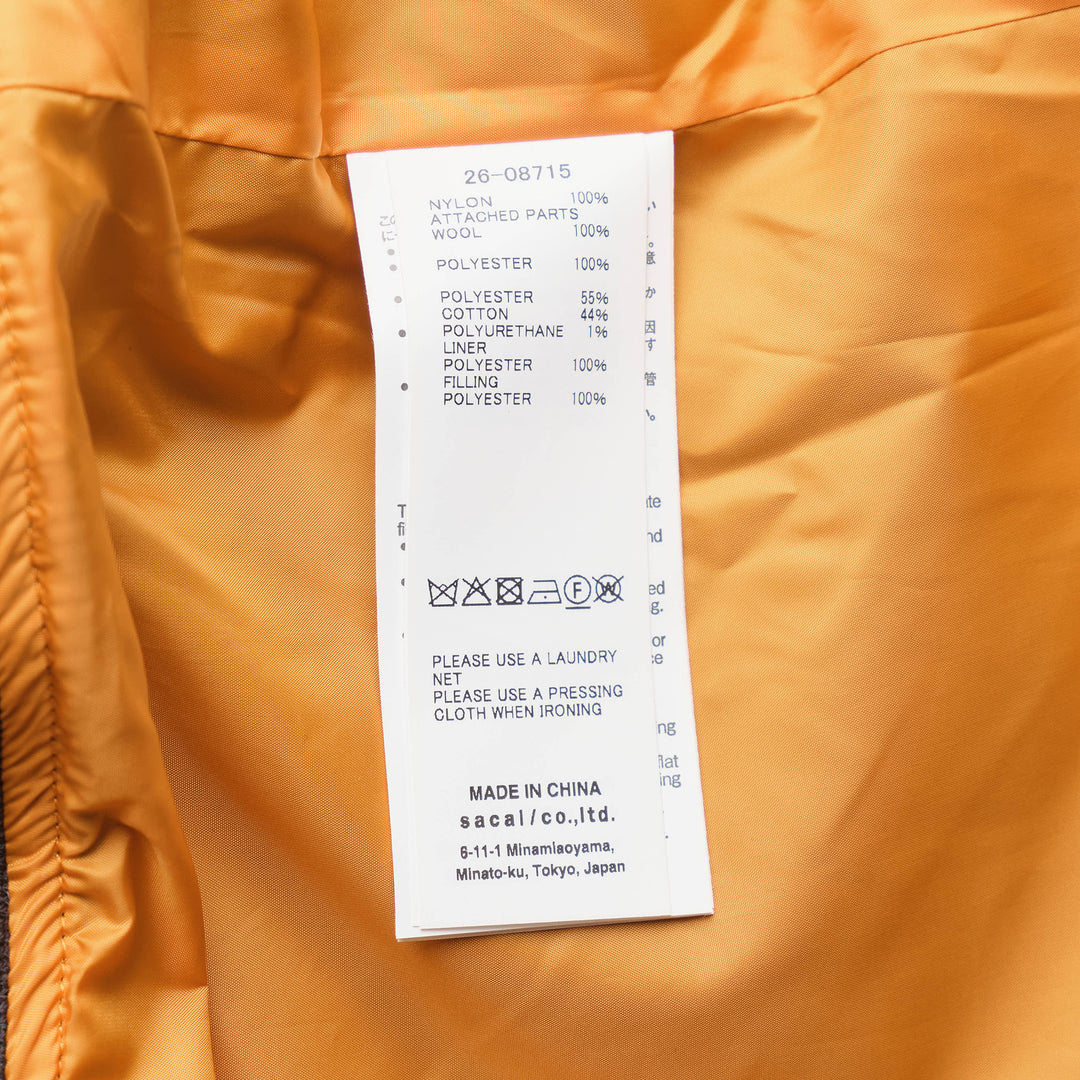 sacai Nylon Twill x Wool Melton Blouson in olive green, featuring an oversized ribbed knit collar, contrast black wool patch pockets, eyelet hardware detail, and orange satin lining at the collar reverse - view 3