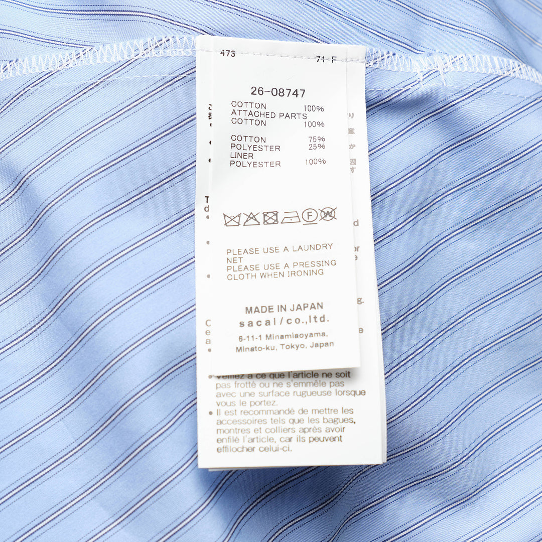 sacai Poplin x Cotton Jersey T-Shirt in black, featuring a crew neck, chest pocket, and light blue pinstripe poplin side panels with a flared hem - view 3