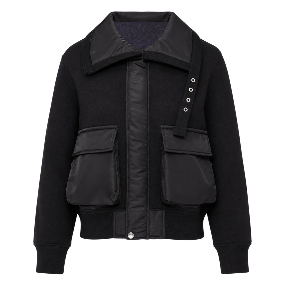 sacai Sponge Sweat Blouson in black, featuring a quilted nylon bib front, oversized spread collar, four cargo pockets, grommet strap detail, and ribbed cuffs
