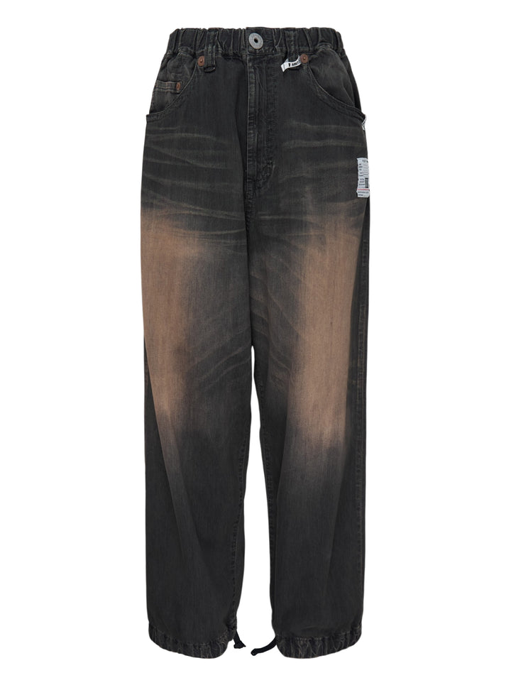 Mihara Yasuhiro Light Oz wide-leg denim pants in a faded black and tan wash with elastic waistband and drawcord hems