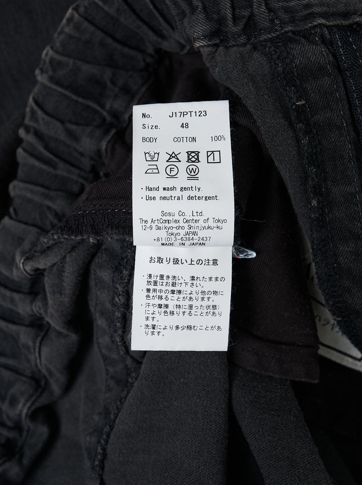 Mihara Yasuhiro Light Oz wide-leg denim pants in a faded black and tan wash with elastic waistband and drawcord hems - view 4