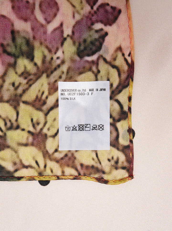 Undercover square scarf featuring a censored fawn with a green bow on a polka dot ground, framed by a red and green floral forest border - view 2