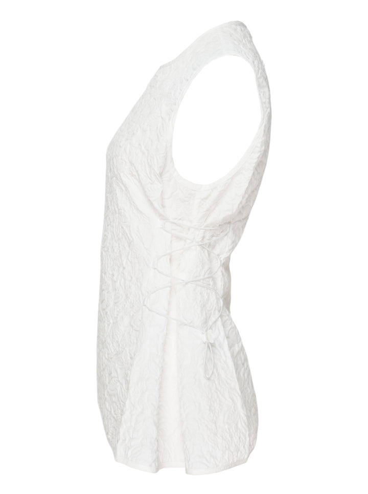 Cecilie Bahnsen Floratini Matelassé sleeveless top in white, shown from the back, featuring an all-over raised floral quilted pattern, gathered bow details along both side seams, and a concealed back zip closure - view 3