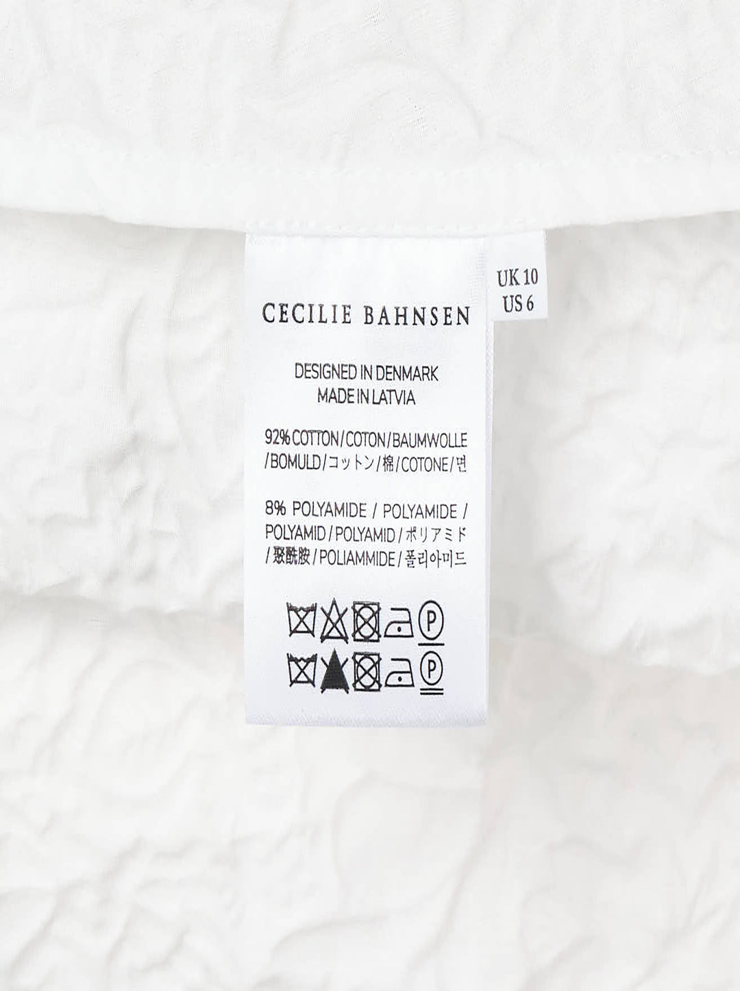 Cecilie Bahnsen Floratini Matelassé sleeveless top in white, shown from the back, featuring an all-over raised floral quilted pattern, gathered bow details along both side seams, and a concealed back zip closure - view 5