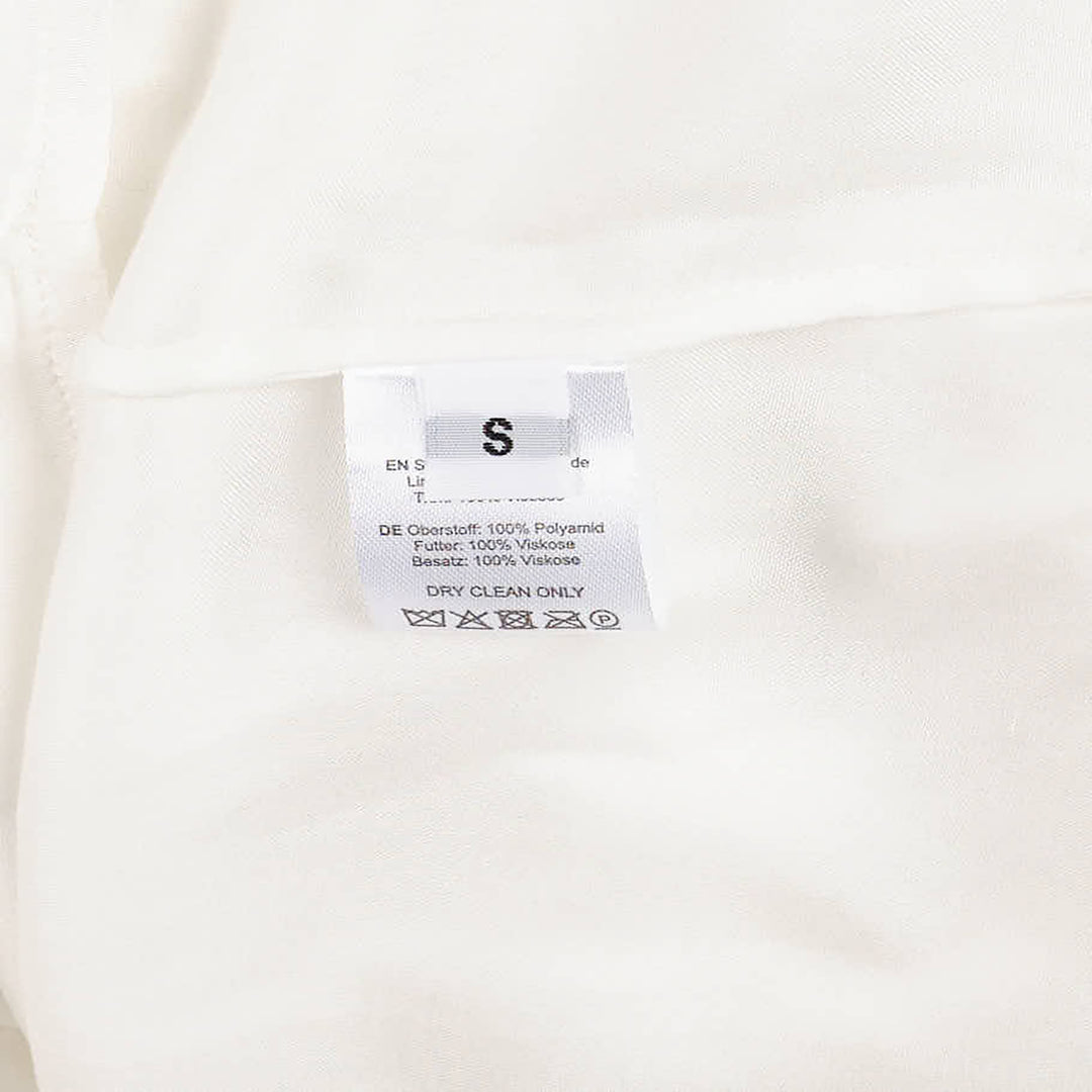 Hisu Park Lolo Dress in white — sleeveless sheer organza mini dress with 3D circular ruffled appliqués across the bodice and a flared drop-waist hem, flat lay view - view 9