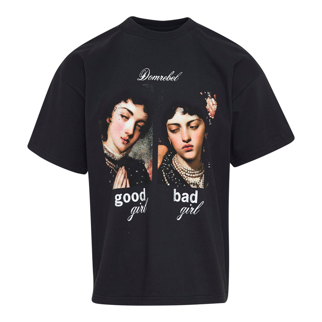 Domrebel black oversized crew-neck tee featuring two Renaissance-style painted female portraits side by side, labelled 'good girl' and 'bad girl', with Domrebel script branding above