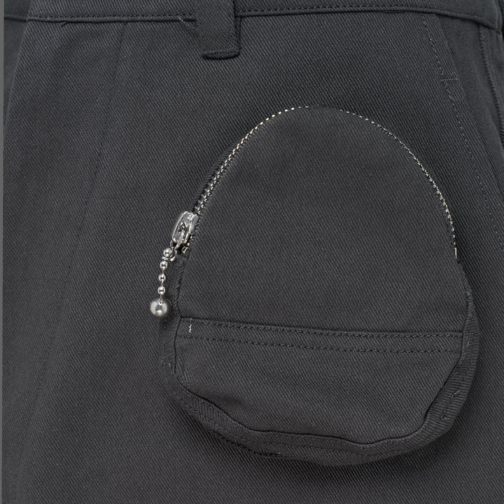 Melitta Baumeister charcoal wide-leg cargo culottes with high waist, sculptural rounded zip utility pocket, and A-line silhouette, shot flat on white background