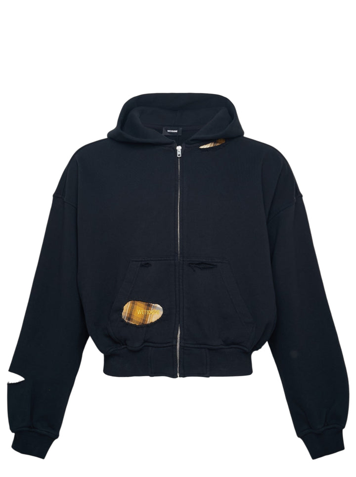 We11done Black Repaired Zip-Up Hoodie with plaid-lined cut-out distressing, silver zip closure, and cropped oversized silhouette, front view on white background