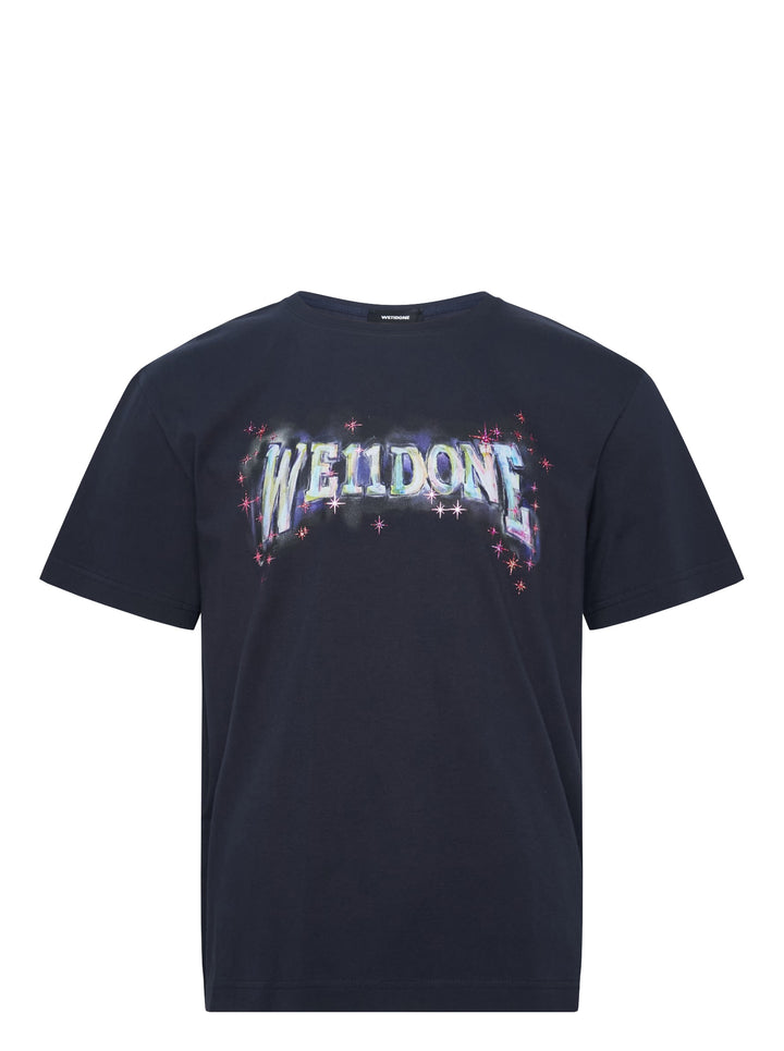 We11done Navy Glowstar T-Shirt with iridescent logo graphic and pink star motifs on a dark navy cotton base, front view