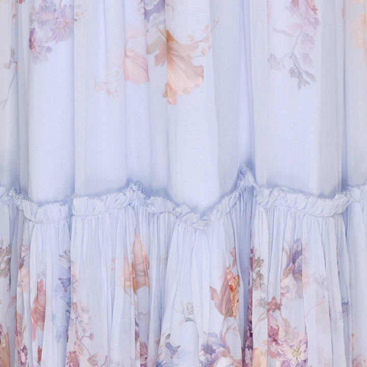 Zimmermann Valiant Flutter Midi Dress in pale blue with watercolour floral print, ruffled high neckline with tassel tie, flutter cap sleeves, printed sash belt, and tiered hem