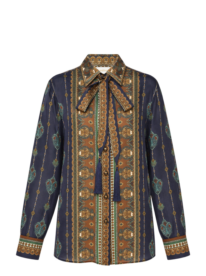 Zimmermann Satin Scarf Blouse in navy and bronze paisley print with self-tie bow collar, tassel ends, and button-through front placket
