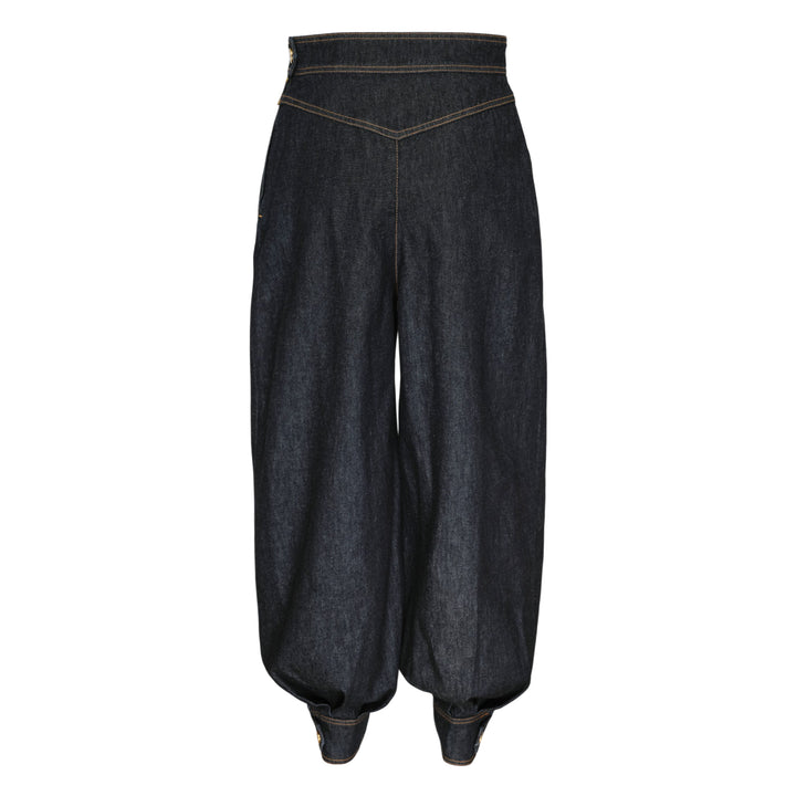 Zimmermann Denim Harem Pants in raw indigo with V-yoke high waist, voluminous balloon legs, gathered ankle cuffs, and contrast gold topstitching — front view on white background
