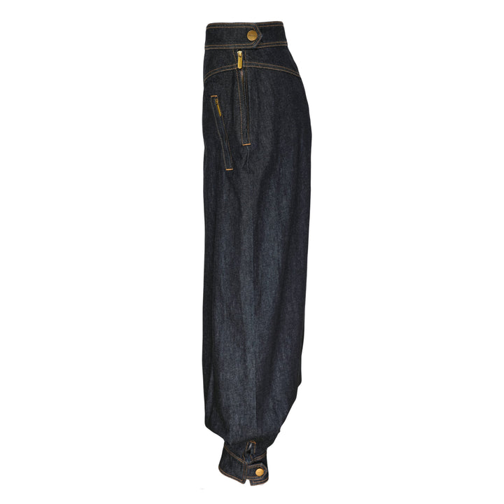 Zimmermann Denim Harem Pants in raw indigo with V-yoke high waist, voluminous balloon legs, gathered ankle cuffs, and contrast gold topstitching — front view on white background