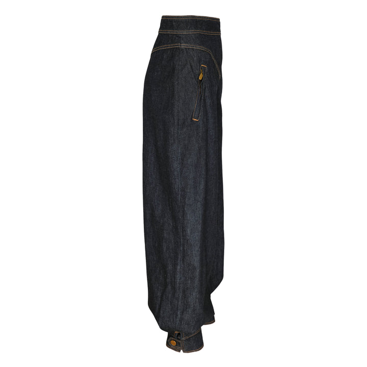 Zimmermann Denim Harem Pants in raw indigo with V-yoke high waist, voluminous balloon legs, gathered ankle cuffs, and contrast gold topstitching — front view on white background