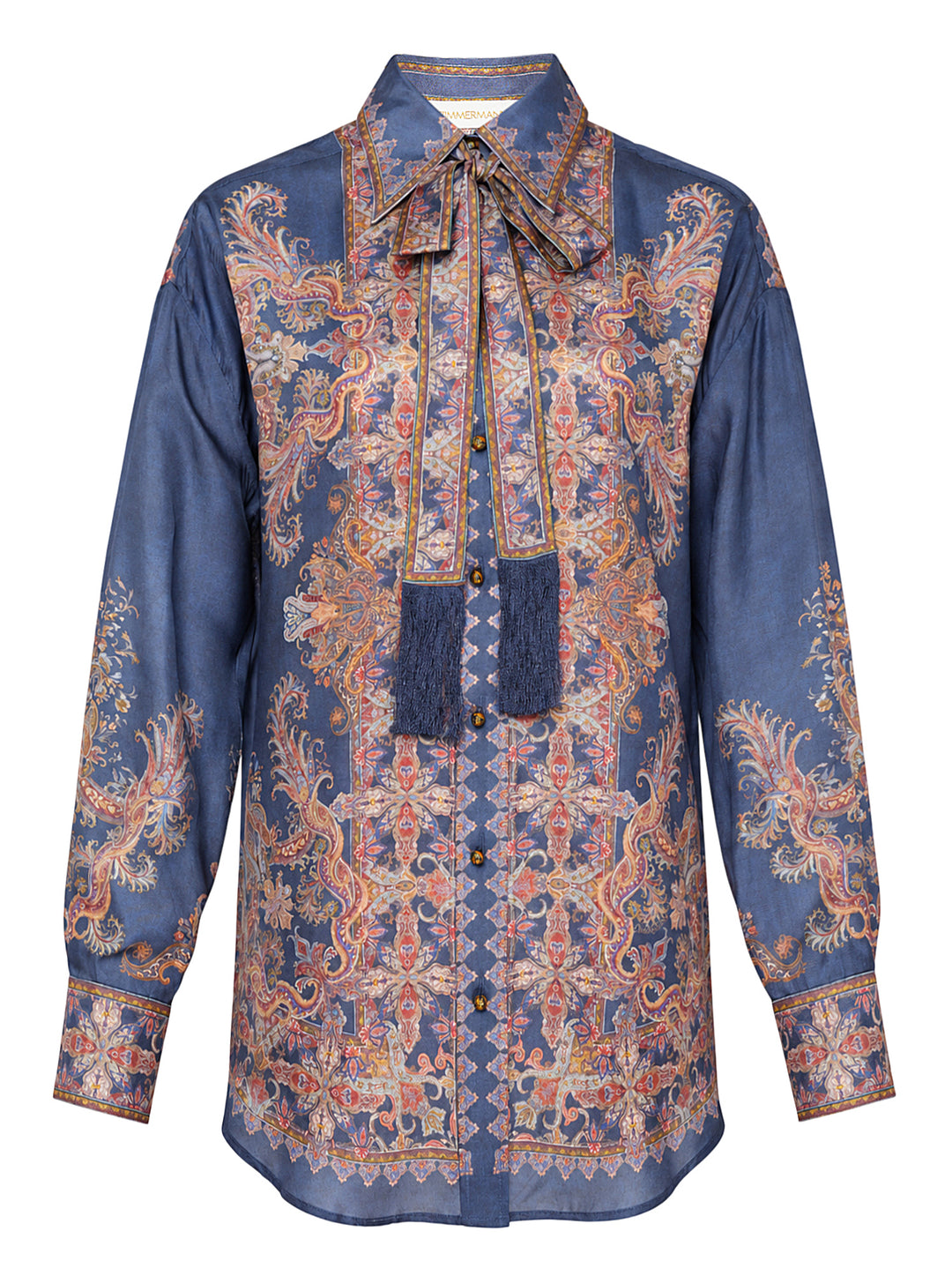 Zimmermann Valiant Relaxed Shirt in indigo blue with ornate paisley and medallion print, featuring a pussy-bow tie, navy tassel, and long buttoned sleeves