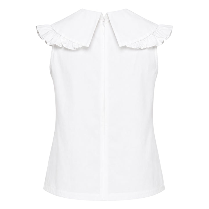 SHUSHU/TONG white sleeveless woven top with ruffled shawl collar and large oversized self-fabric bow at the centre front, photographed against a white background