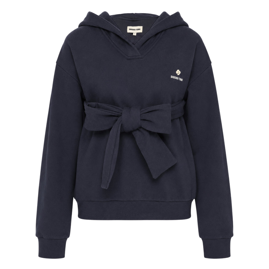 SHUSHU/TONG navy Tie Front Bow Hoodie with an oversized self-fabric bow at the waist, open V-neckline, and embroidered logo on the chest