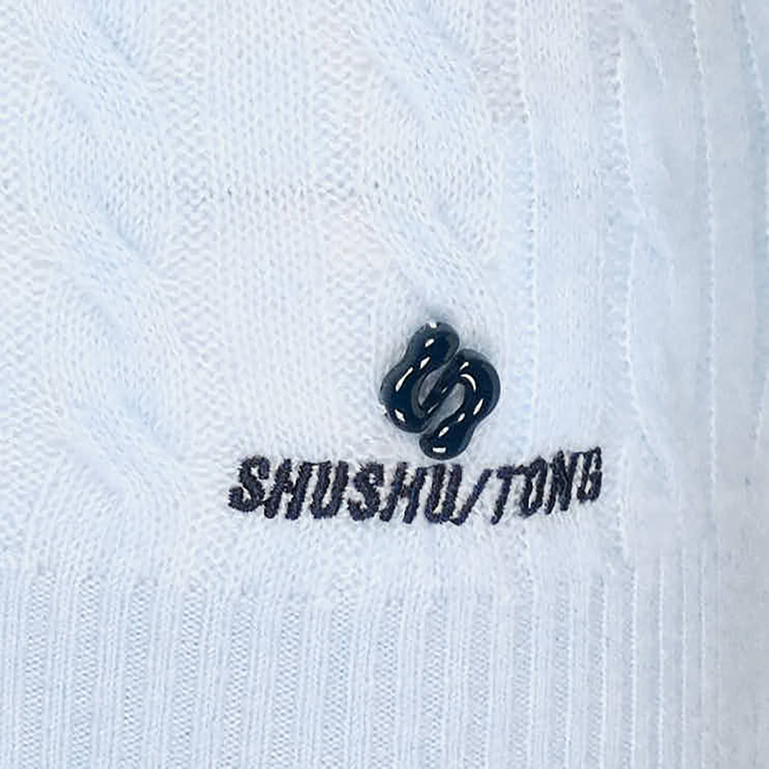 SHUSHU/TONG V-Neck Cable Knit Sweater in baby blue with open collar, all-over cable texture, and ribbed cuffs and hem