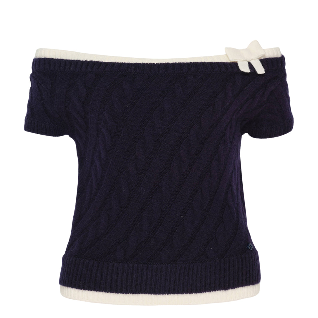 SHUSHU/TONG baby blue cable-knit off-shoulder crop top with cream contrast ribbed trim, bow accent at the neckline, and short sleeves, displayed flat on a white background