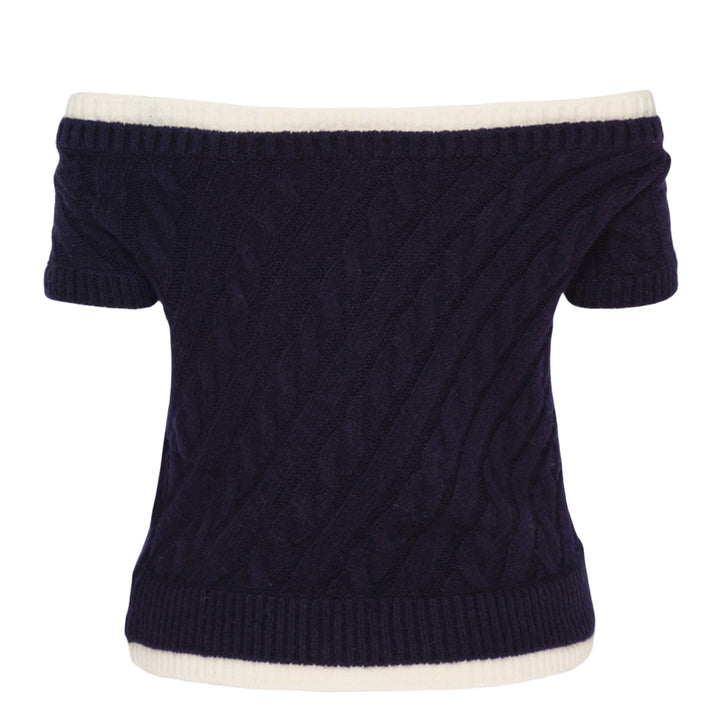 SHUSHU/TONG baby blue cable-knit off-shoulder crop top with cream contrast ribbed trim, bow accent at the neckline, and short sleeves, displayed flat on a white background
