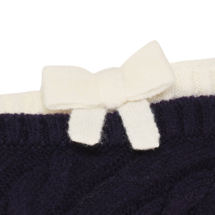 SHUSHU/TONG baby blue cable-knit off-shoulder crop top with cream contrast ribbed trim, bow accent at the neckline, and short sleeves, displayed flat on a white background