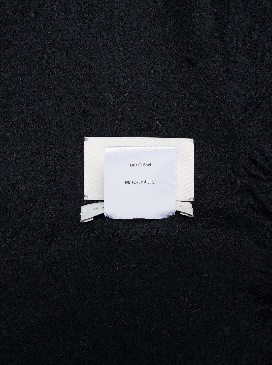 Black soft brushed rectangular scarf with feathered fringe edges, shown flat - view 3