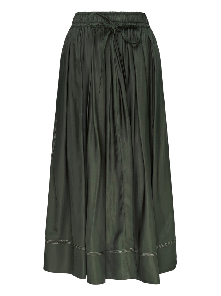 Lee Mathews Sloane Pleat Midi Skirt in deep forest green, featuring a smocked elastic waistband with drawstring tie, voluminous gathered pleats, and contrast hem stitching