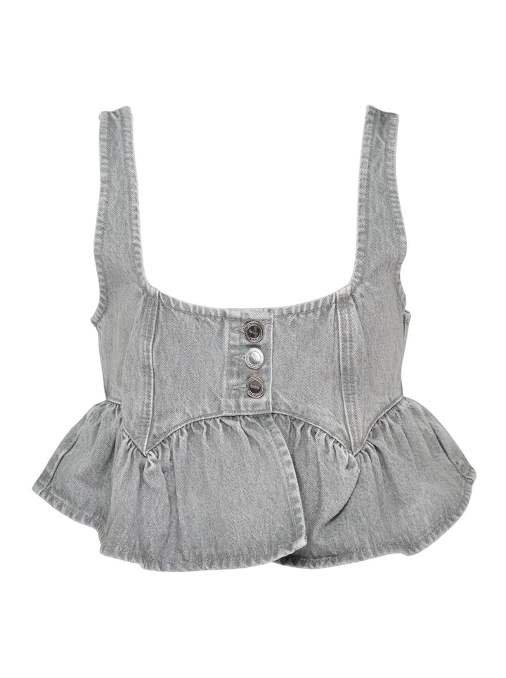 Ganni Rigid Denim Flounce Top in light grey wash, featuring a structured seamed bodice, three branded silver snap buttons at the centre front, wide shoulder straps, scoop neckline, and a gathered peplum ruffle hem