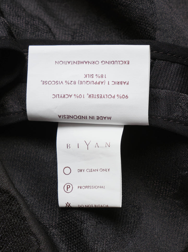 Biyan black lamé jacquard wide leg trousers with all-over rose brocade pattern, broderie anglaise cutwork floral hem border with beaded scallop edging, and velvet cuff finish, photographed flat on a white background - view 4