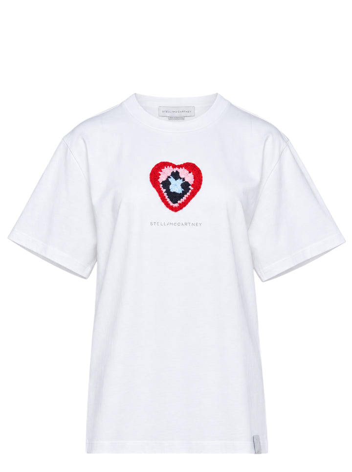 Stella McCartney white boyfriend T-shirt with a multicolour crochet heart appliqué at the chest and tonal logo print, shown flat on a white background