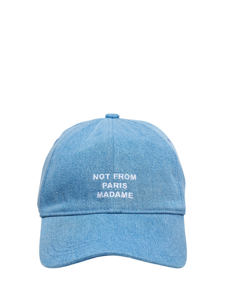 Drôle de Monsieur light blue washed denim baseball cap with white embroidered 'Not From Paris Madame' slogan on the front panel, front view