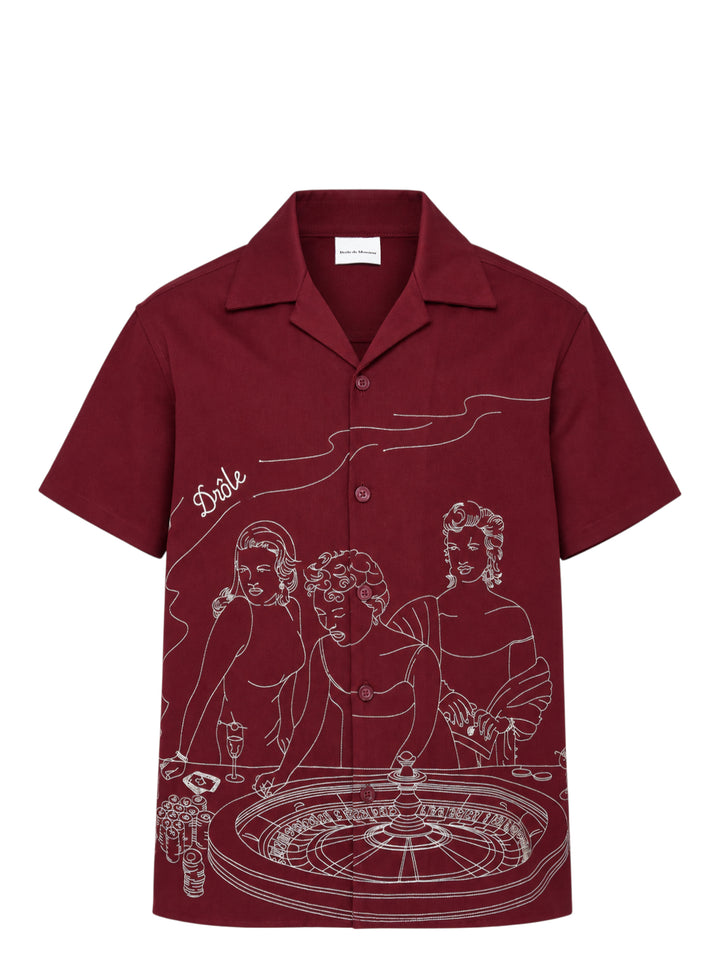Drôle de Monsieur burgundy short sleeve camp collar shirt with white embroidered illustration of three women at a roulette table