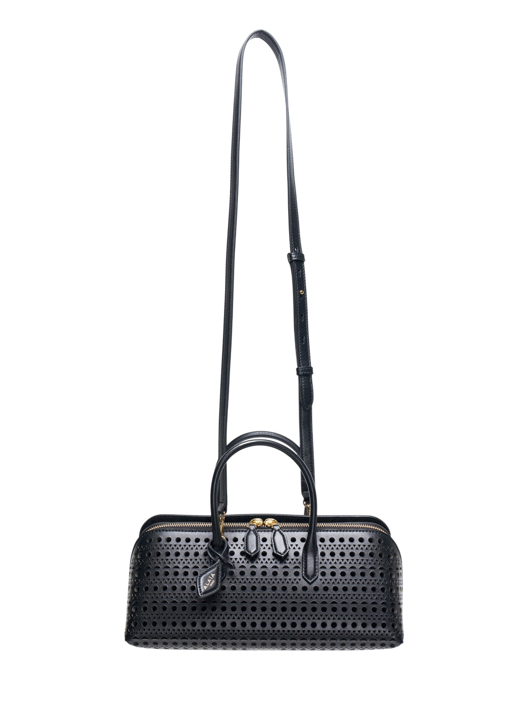 Alaïa Delta S top handle bag in black perforated leather with circular and triangular cutout pattern, dual rolled handles, gold-tone zip closure, and a long adjustable crossbody strap, shown on a white background