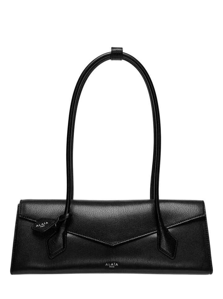 Alaïa Teckel Flap Medium shoulder bag in black shiny goatskin with elongated silhouette, V-point envelope flap closure, and twin handles fastened with a leather ring