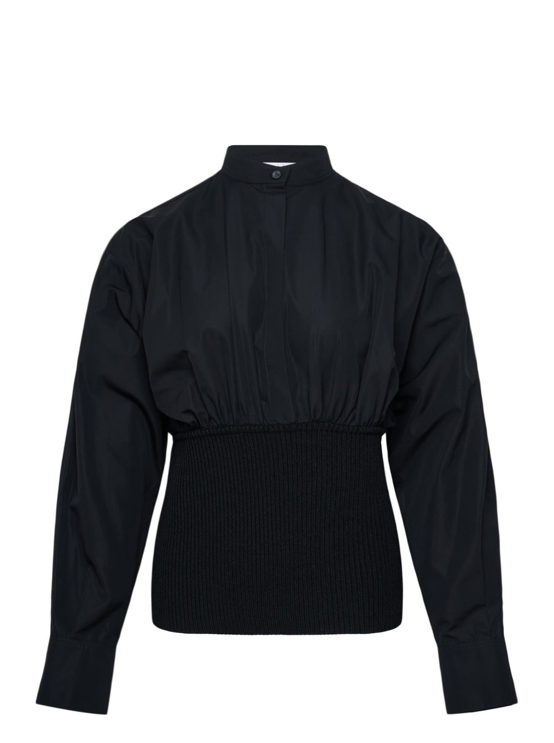 Alaïa Cinched Cotton Poplin Shirt in black, featuring a voluminous poplin upper, mandarin collar with button fastening, long sleeves, and a structured ribbed knit cinched waistband