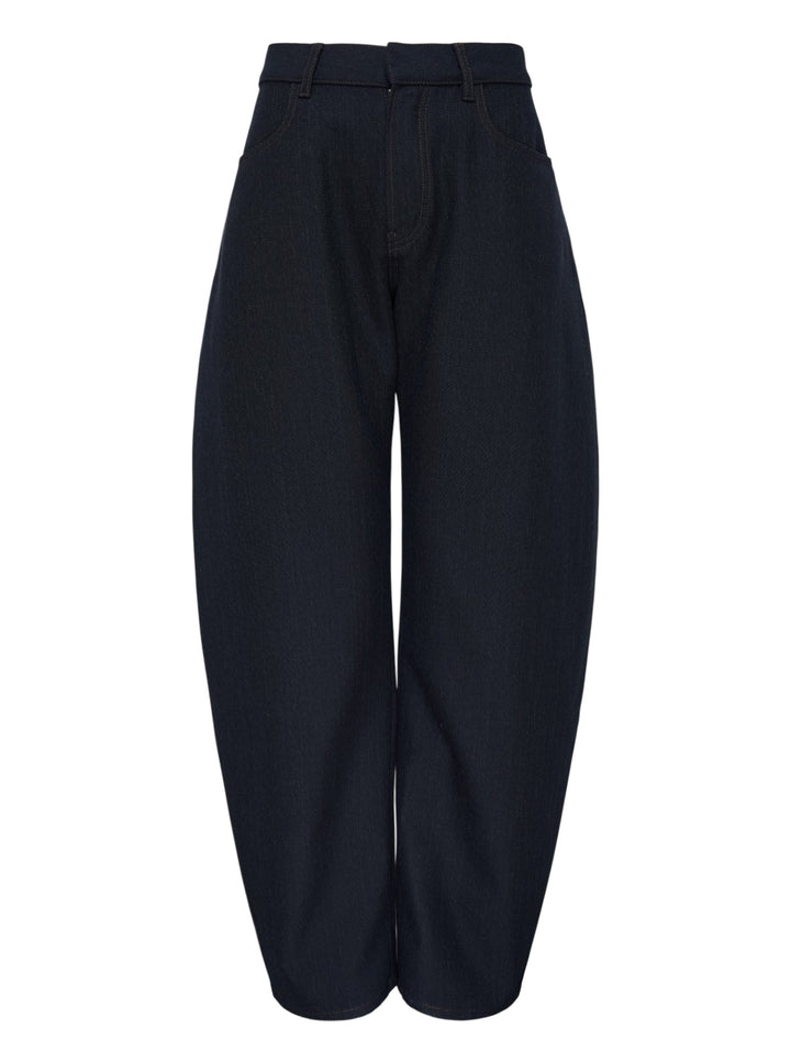 Alaïa round pants in dark navy wool denim with a high waist, curved barrel leg and contrast topstitching, shown from the front