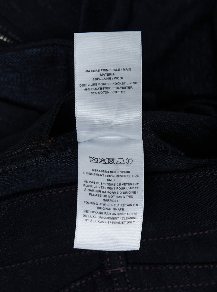 Alaïa round pants in dark navy wool denim with a high waist, curved barrel leg and contrast topstitching, shown from the front - view 3