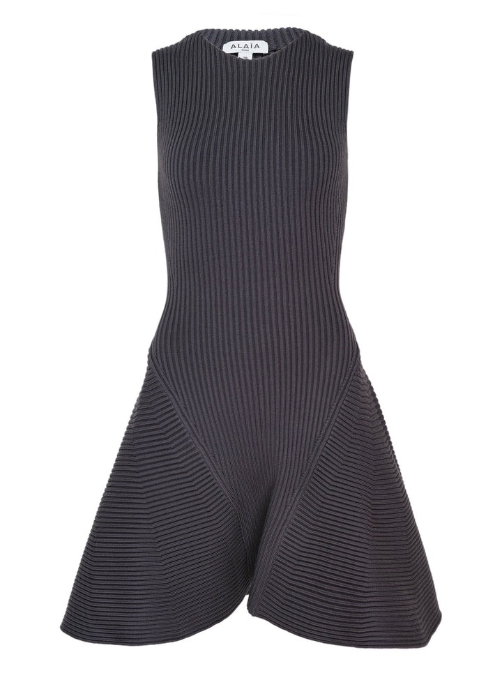 Alaïa Engineered Ribs Skater Dress in charcoal grey, featuring a fitted vertical-ribbed bodice and a flared skirt with geometric horizontal ribbed panels, sleeveless with a round neckline