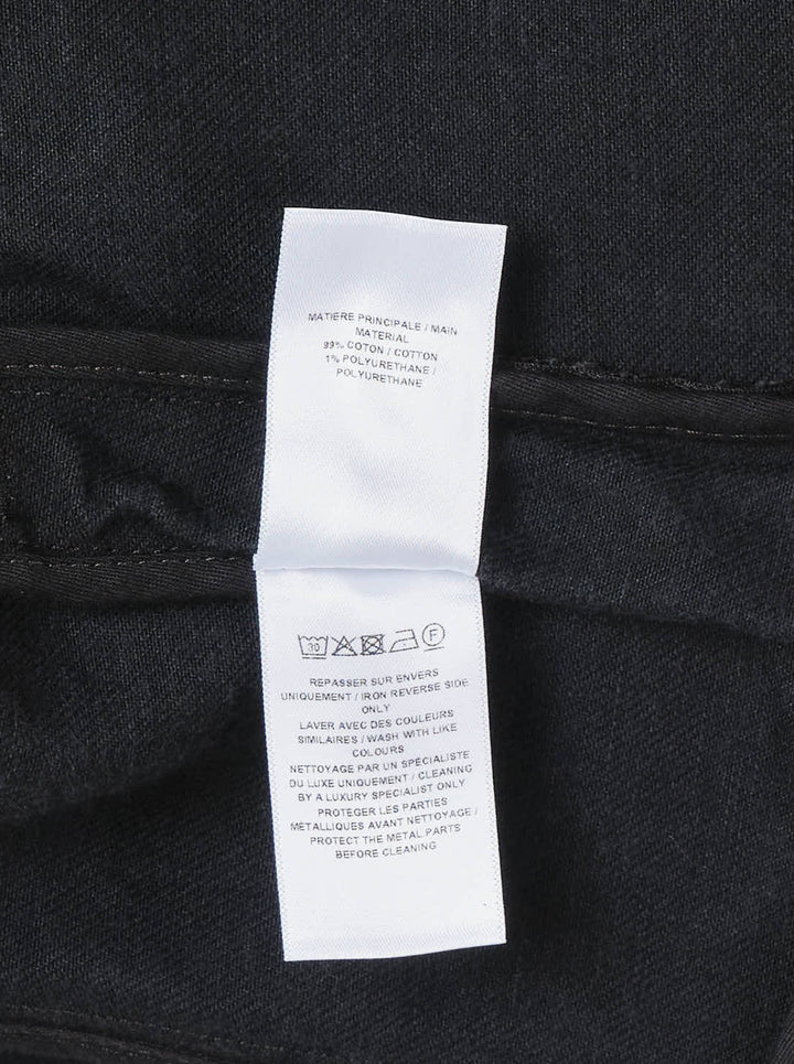 Alaïa Black Denim Biker Jacket with asymmetric silver-tone zip, corset seaming, and cropped curved hem, shown flat on white background - view 3