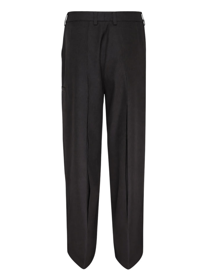 Melitta Baumeister Tailored Pointy Hem Pants in black, featuring raised front seam lines and a signature pointed hem extending at each leg, with a high-rise single-button waistband — front view on white background - view 2