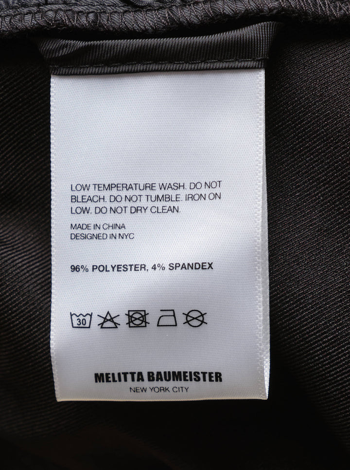 Melitta Baumeister Tailored Pointy Hem Pants in black, featuring raised front seam lines and a signature pointed hem extending at each leg, with a high-rise single-button waistband — front view on white background - view 3