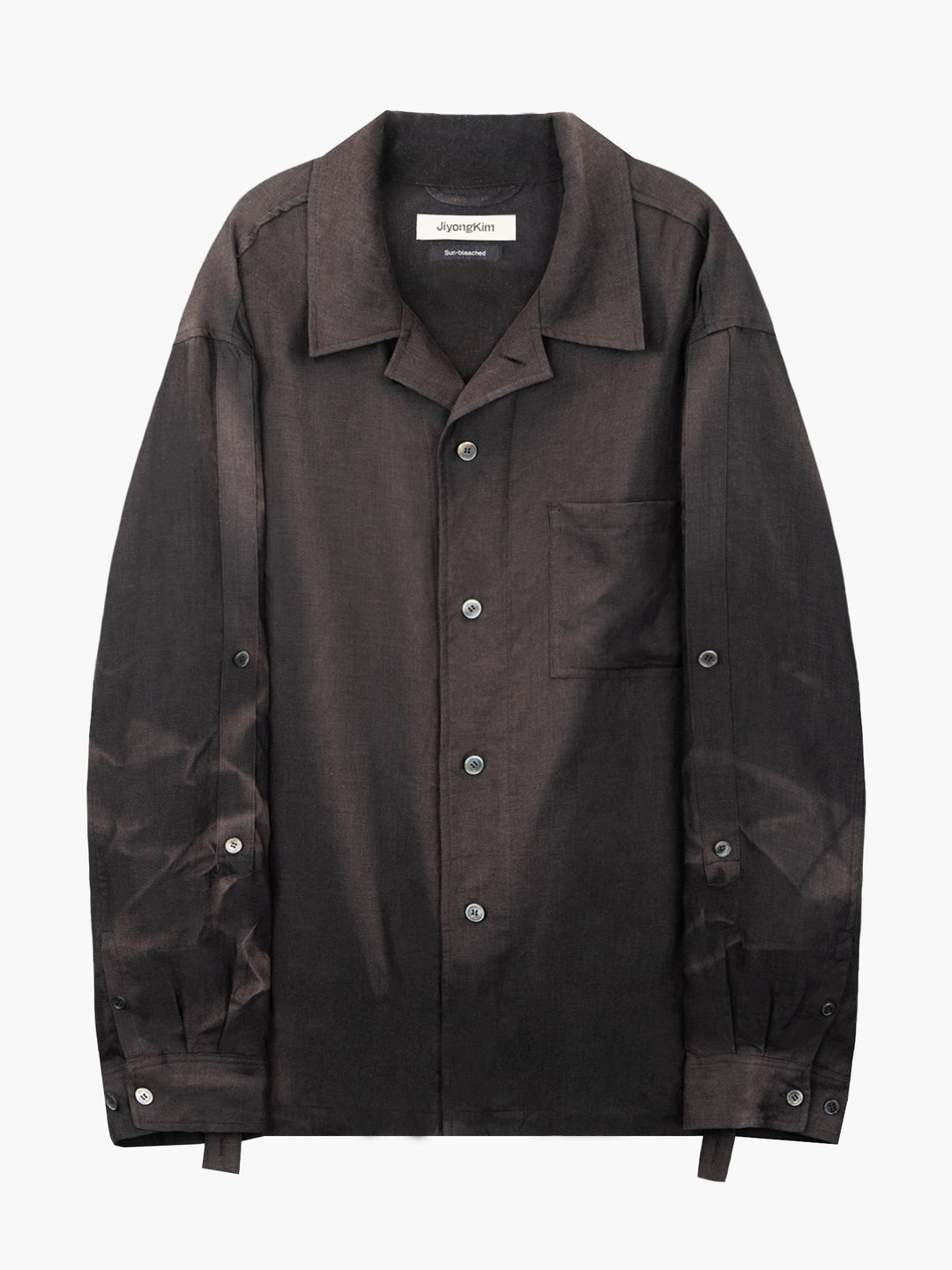 JiyongKim Sun-Bleached Strap Shirt in faded dark brown with open camp collar, chest pocket, button front and adjustable sleeve straps